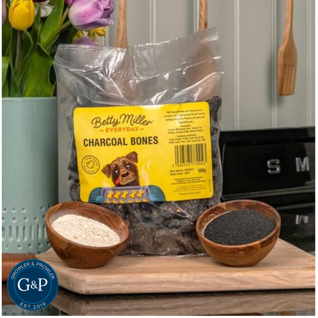 A close-up of Betty Miller Charcoal Bones, a natural dog treat made from charcoal, known for its benefits in aiding dog digestion. The treats are bone-shaped and have a dark, appealing texture. Perfect for dog owners and breeders, these popular treats help reduce unpleasant smells while being loved by dogs.