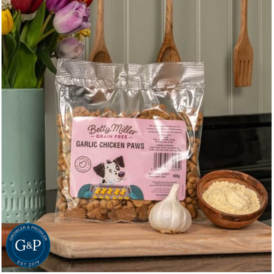 A close-up of Betty Miller Garlic Chicken Paws, a tasty and healthy snack for dogs. The treats are made with real chicken and garlic and are packaged in a clear plastic bag.