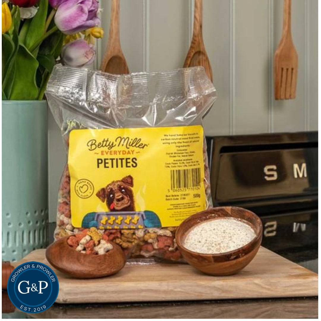 An assortment of Betty Miller Petites dog treats displayed attractively. These biscuits, available at Growler & Prowler in Manchester, are made from simple, wholesome ingredients designed to be tasty and enjoyable for dogs.