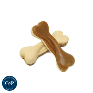 Two bone-shaped dog treats from Growler and Prowler. They are white and brown and have a peanut butter flavour