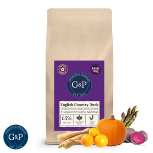 A brown paper bag of Growler & Prowler English Country Duck dog food. The bag features the company logo, information about the product, including the ingredients and nutritional content, and graphics of various vegetables and fruits.