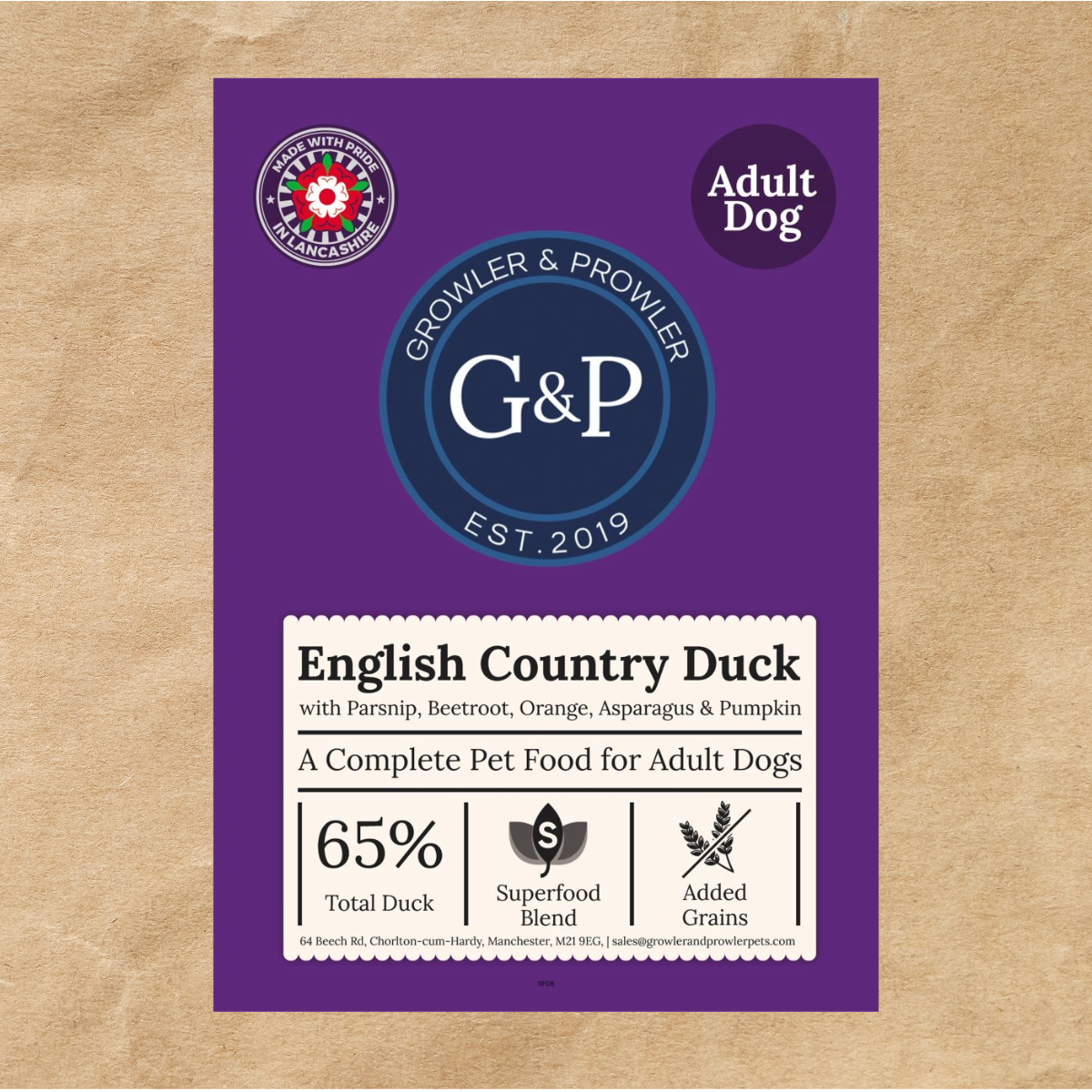 A brown paper bag of Growler & Prowler English Country Duck dog food. The bag features the company logo, information about the product, including the ingredients and nutritional content, and graphics of various vegetables and fruits.